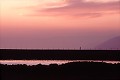 California tourist people pictures man walks on jetty, dusk stock photo
