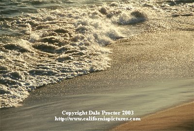 California coast water patterns on sand beach stock photos