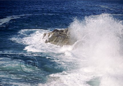 coastline waves on rocks, ocean spray in air