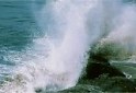 big wave water crashing rocks sea spray