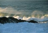 rocky shore large rolling misting wave