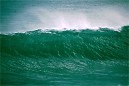 deep green waves from storm high in curl
