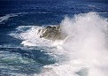 water wave breaks on shore coastal rocks