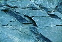 picture line cracks along blue gray rocks